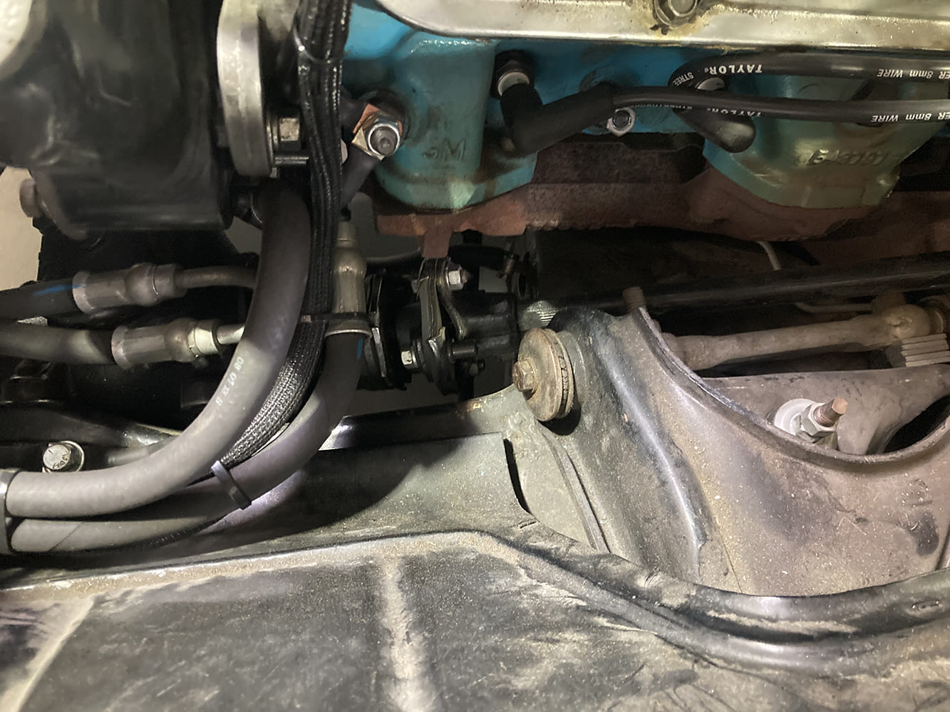 03 1964 Pontiac GTO steering linkage and column through firewall showing coupler and suspension proximity