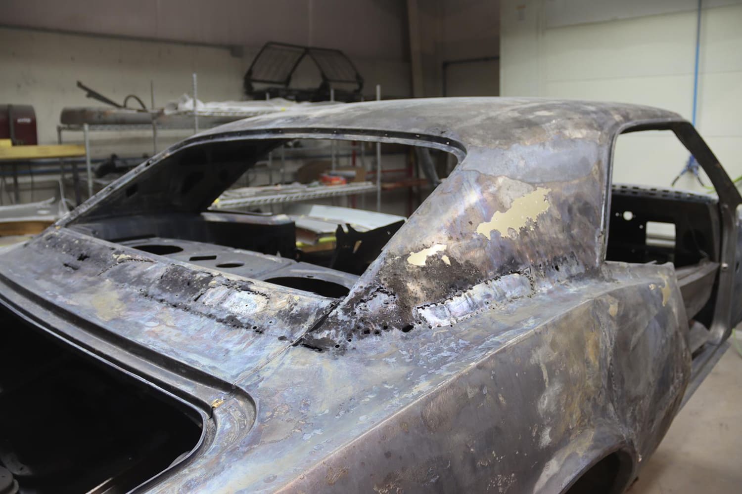 03 1967 Pontiac Firebird rear window channel stripped showing rust repair and panel replacement in progress