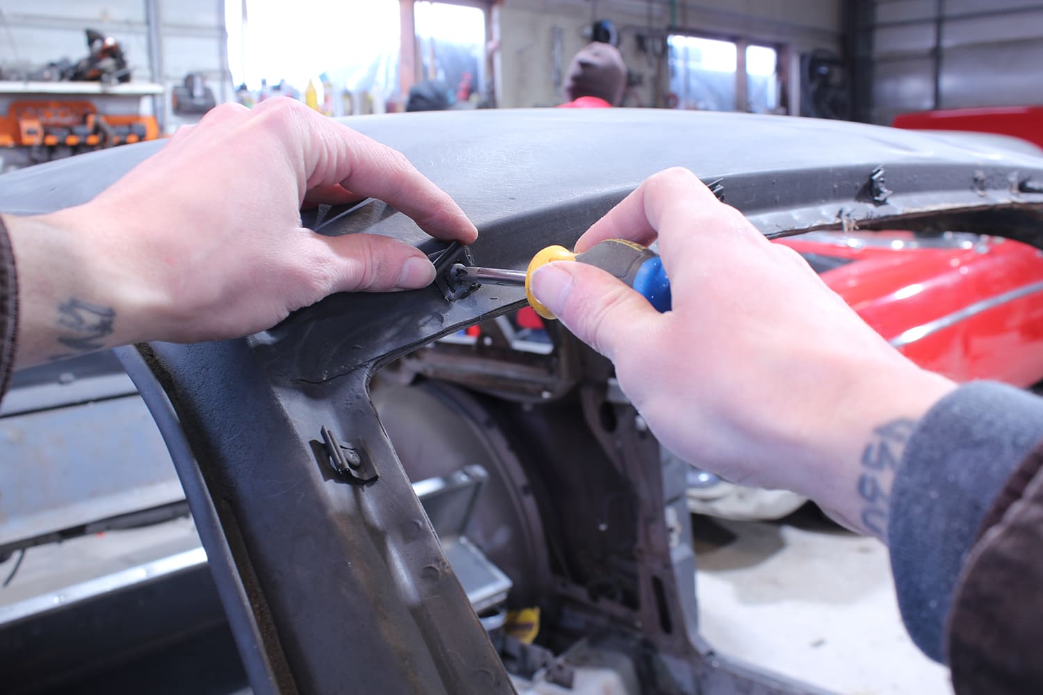 03 Technician begins trim and molding clip removal from 1965 Mustang roof line