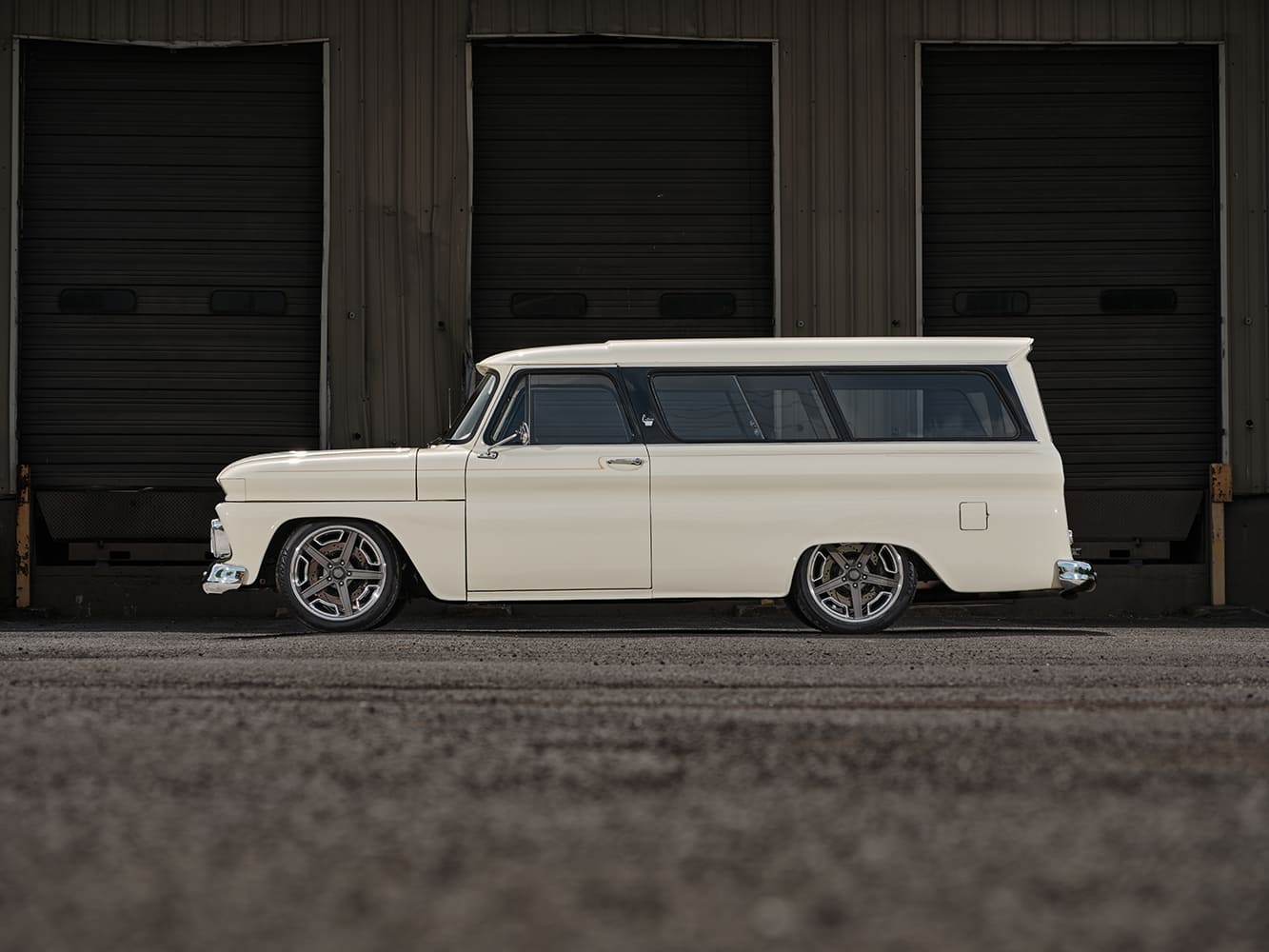 04 1966 Chevrolet Suburban side view showcasing shaved trim flush glass and deep dish rear wheels