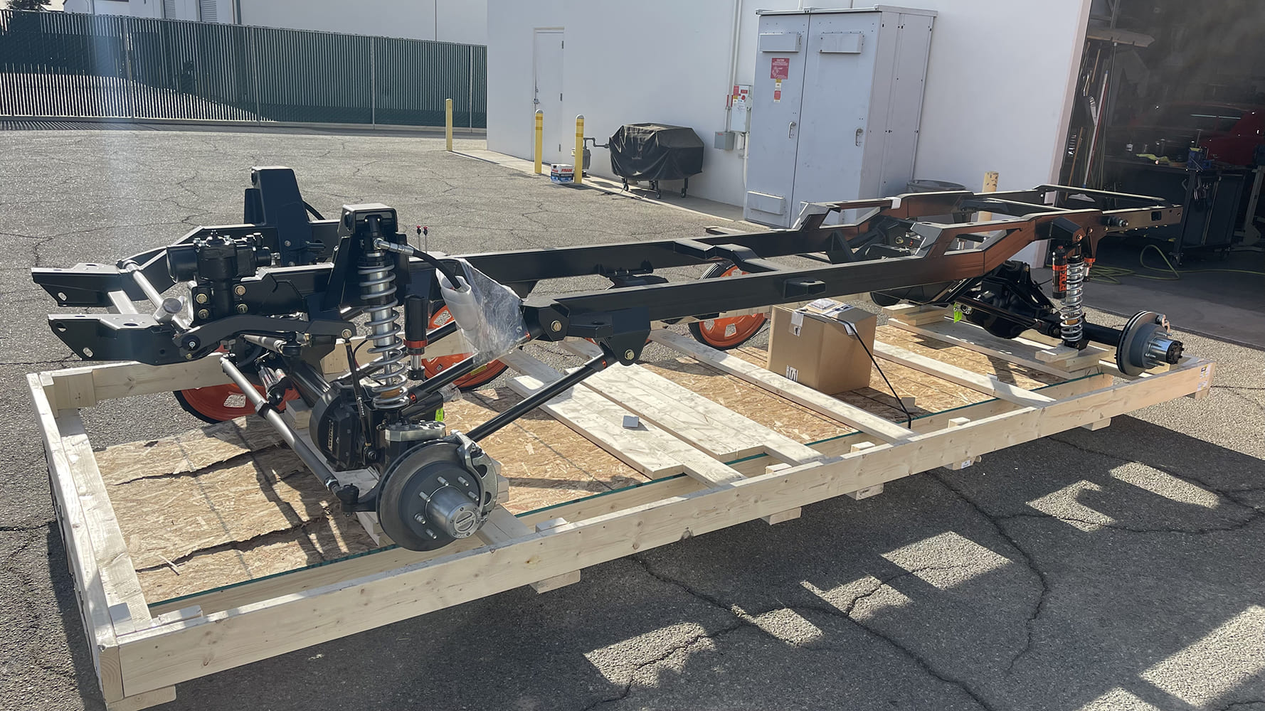 04 1985 chevy squarebody rtech coilover chassis mocked up on shipping pallet with boxed frame