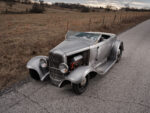 07 1932 Ford Roadster raw steel finish black steel wheels moon caps front three quarter view
