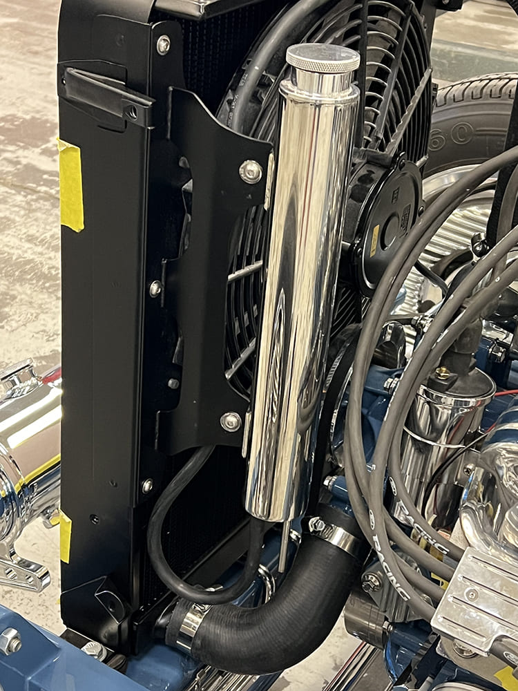 08 1929 Ford Roadster close up of aluminum radiator with chrome overflow tank and electric fan setup