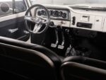 09 1966 Chevrolet Suburban interior showing 3 spoke billet steering wheel manual shifter and dual bucket seats