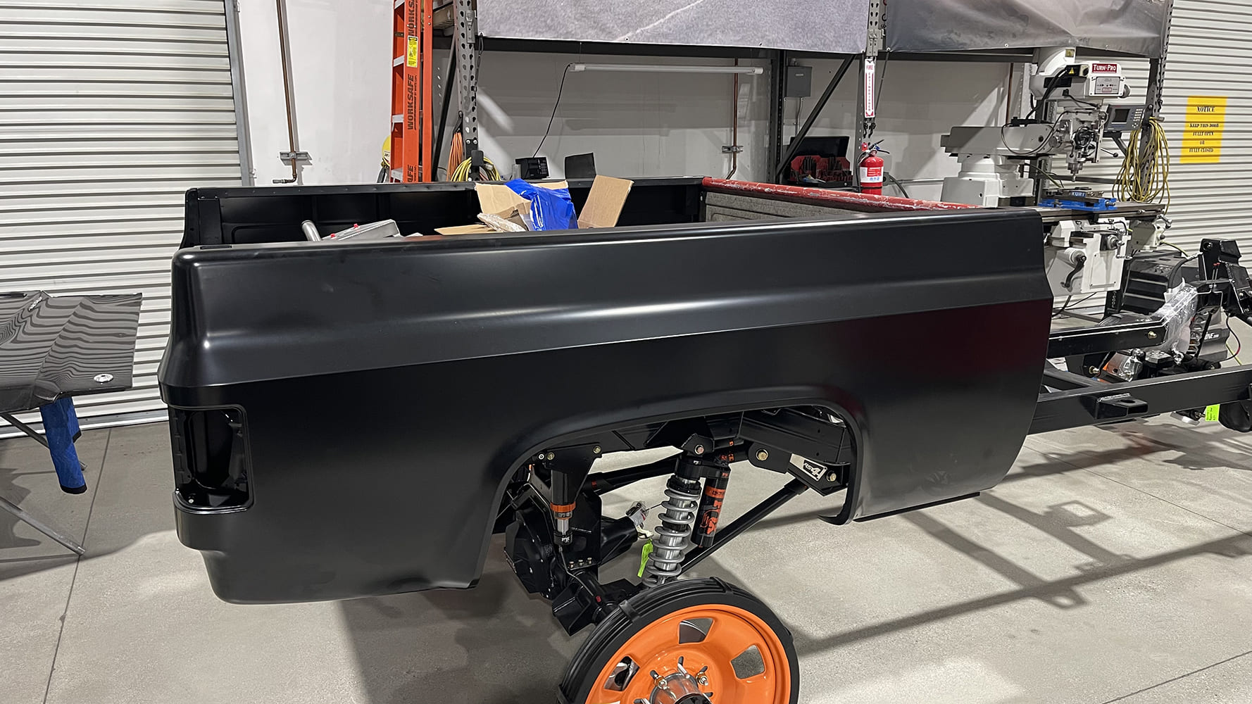 09 1985 chevy squarebody front suspension close up with goodyear wrangler tire and raceline forged wheel