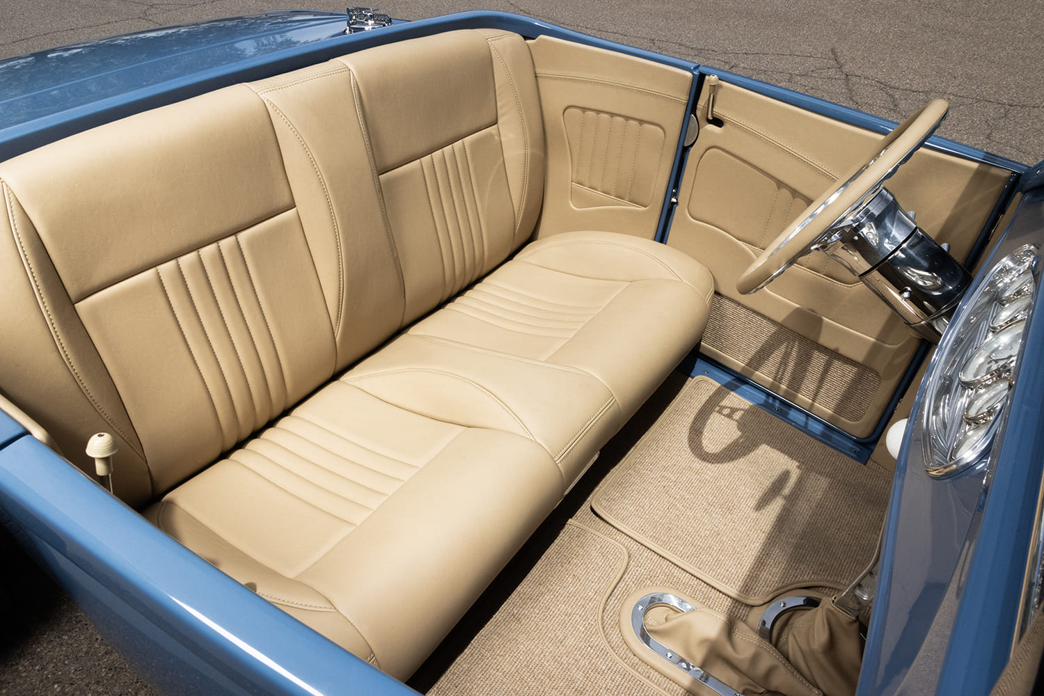 10 1929 Ford Roadster interior view showcasing custom stitched upholstery and billet steering wheel