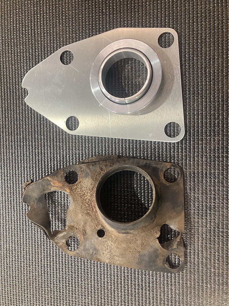 11 1964 Pontiac GTO billet firewall plate with bearing next to rusted factory steering column plate
