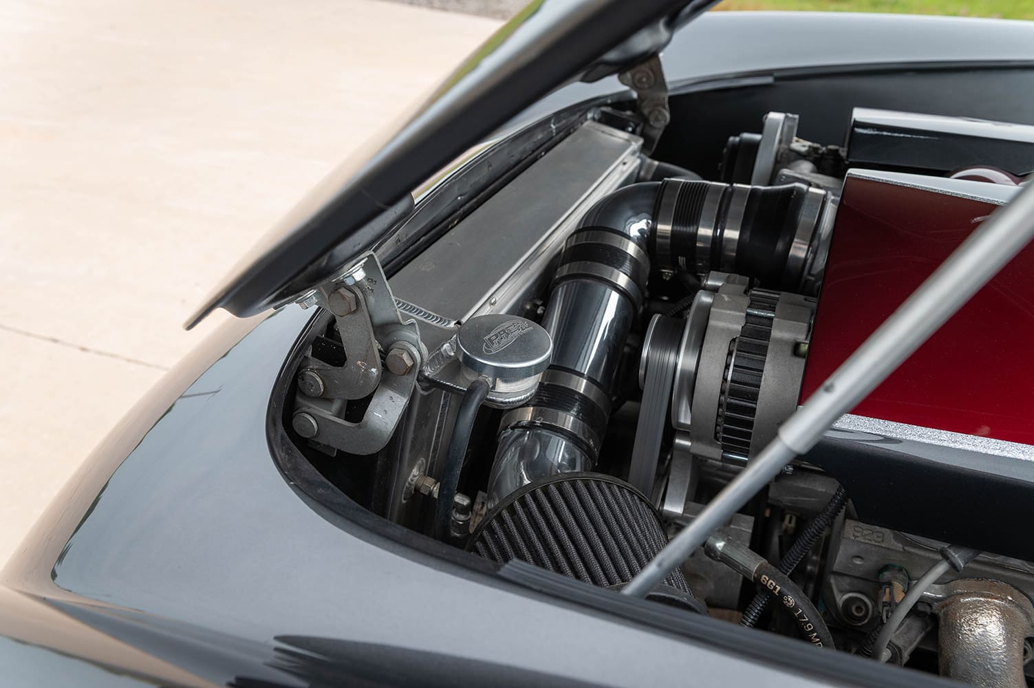 12 1956 Corvette engine bay showing aluminum radiator black intake tube and conical air filter