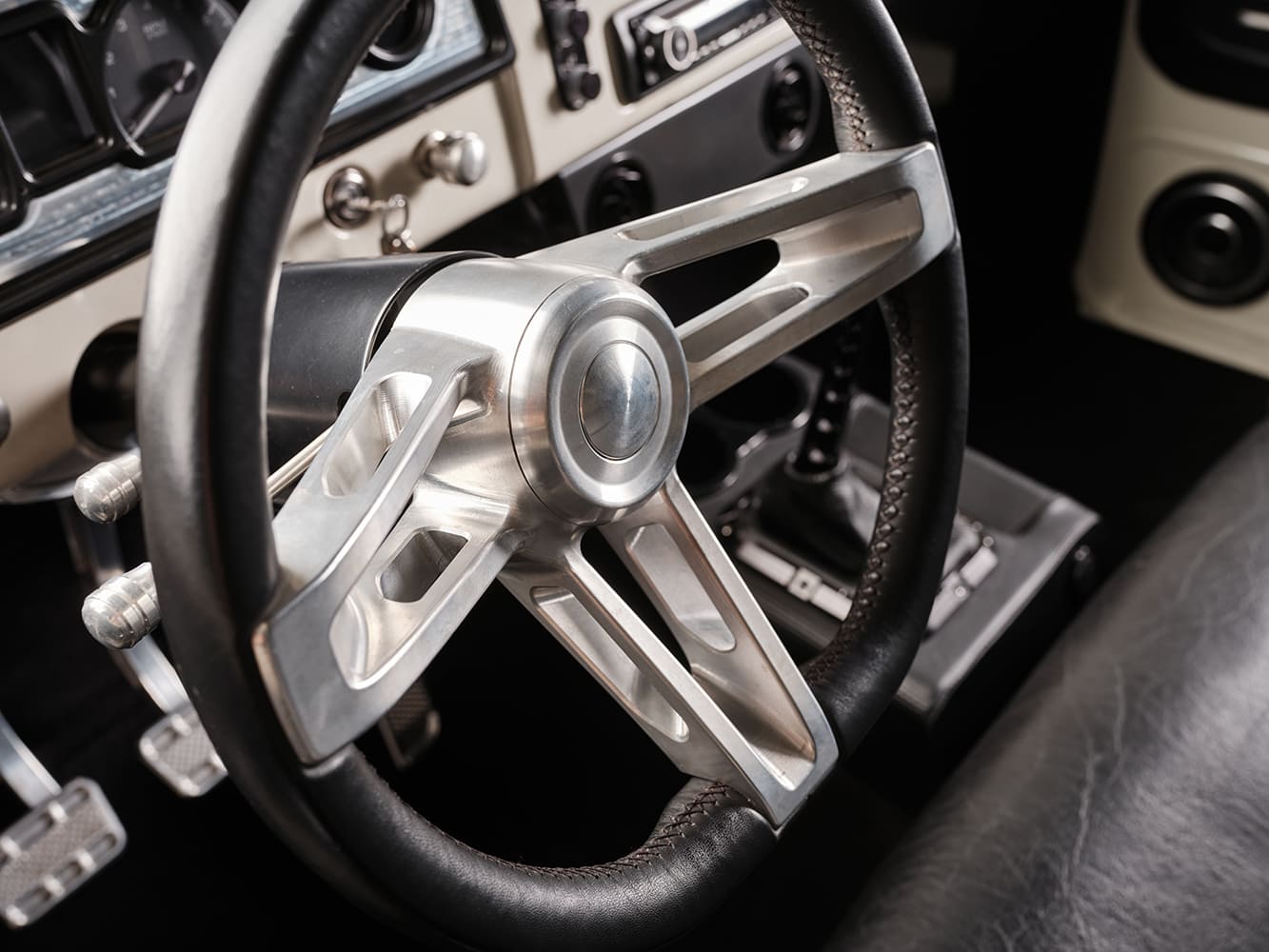 12 1966 Chevrolet Suburban billet steering wheel with leather wrap and manual shifter visible in center console