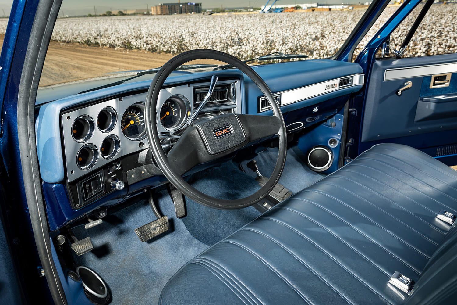 12 1981 GMC K15 interior view steering wheel gauge cluster bench seat