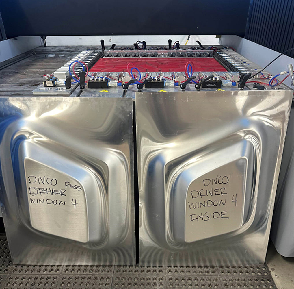 14 Divco hydroformed window panels labeled for driver and passenger side use with sharp tooling detail