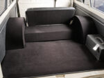 15 1966 Chevrolet Suburban rear cargo area with custom carpeted panels subwoofer box and seat back contrast