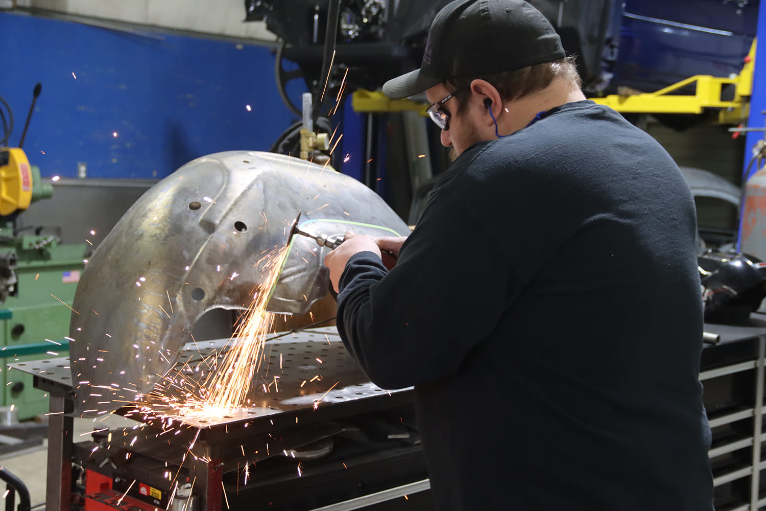 15 1967 Firebird wheel tub being trimmed with cutoff wheel during mini tub conversion for wider tires