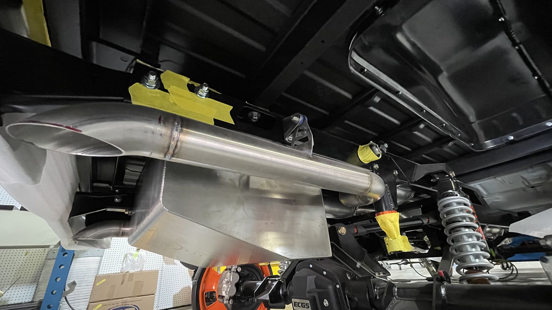 18 1985 chevy squarebody rear coilover and exhaust mockup under bed with raw tubing and mounts