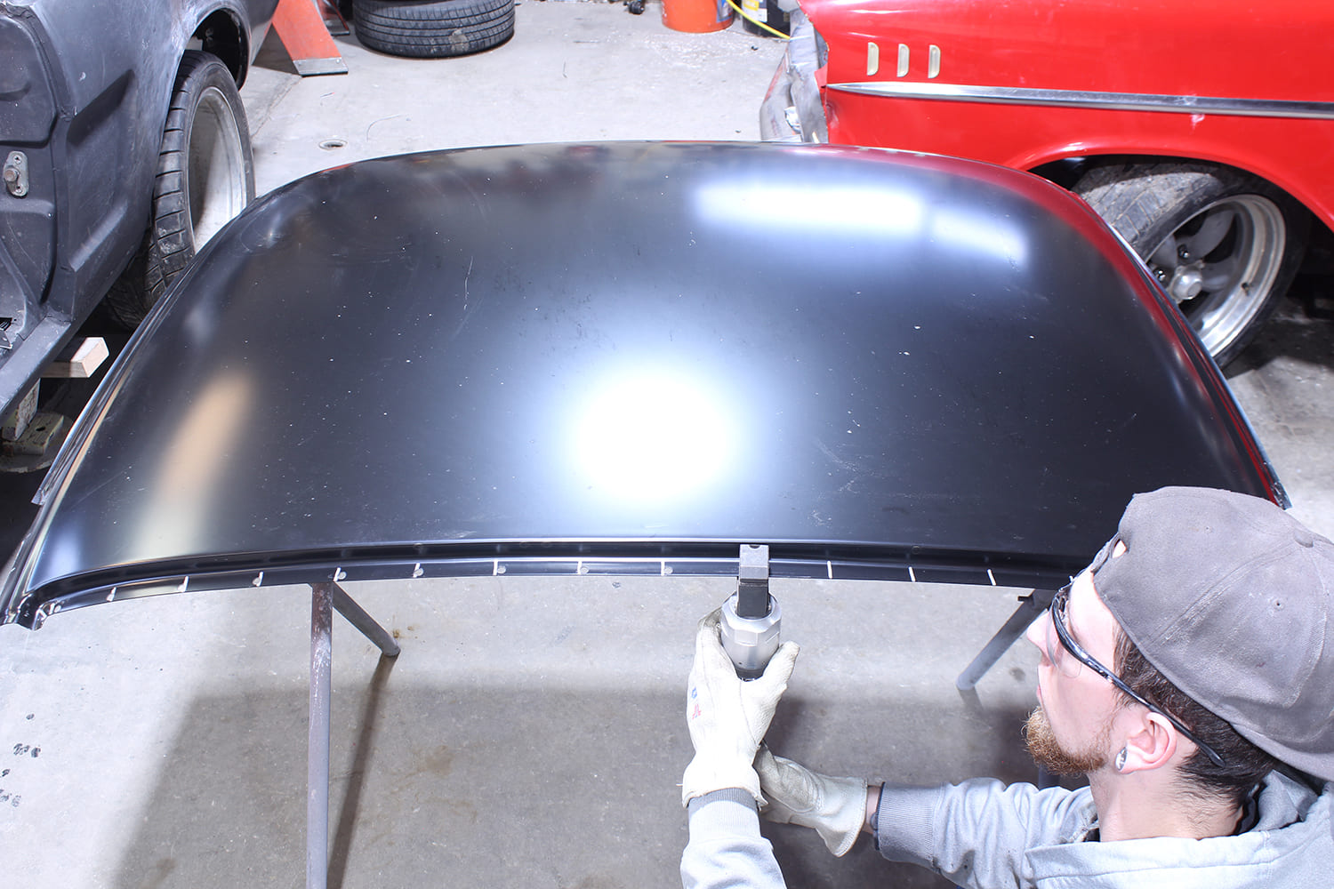 18 New roof panel's inner flange is punched to prepare for plug welds