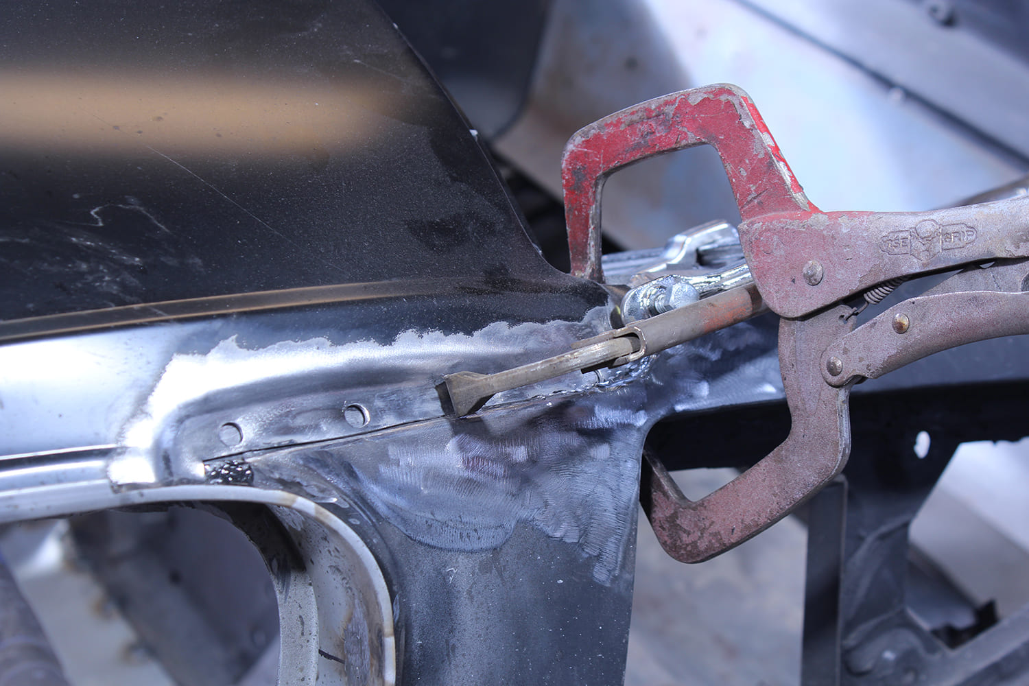 22 Torch heating lead solder while tinned seam is filled on a 1965 Mustang Fastback roof joint