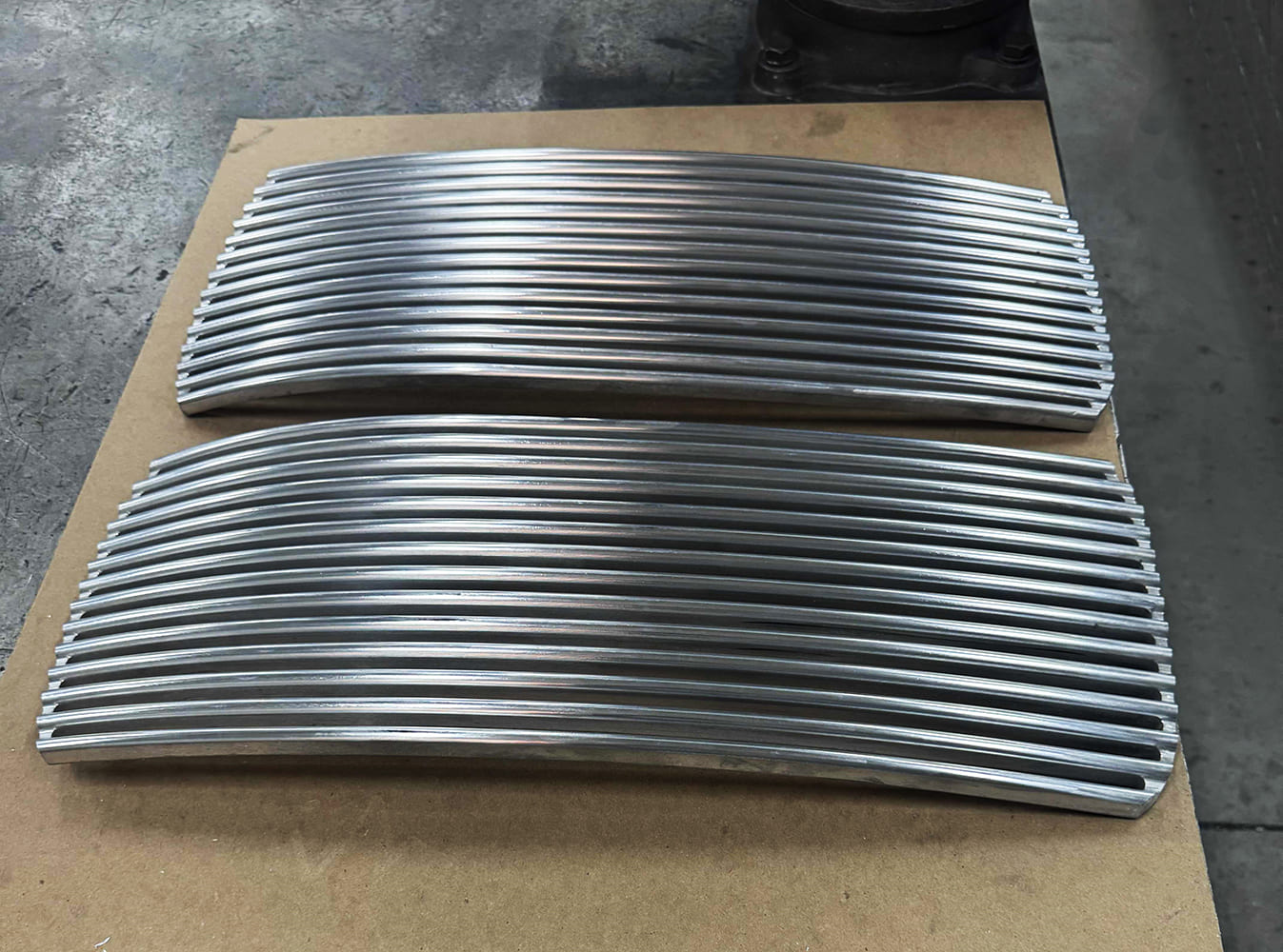 26 Divco custom grille bars CNC machined in curved profile with consistent spacing and taper