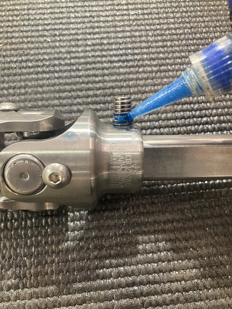 27 1964 Pontiac GTO applying Loctite to Borgeson style U joint set screw for anti vibration security