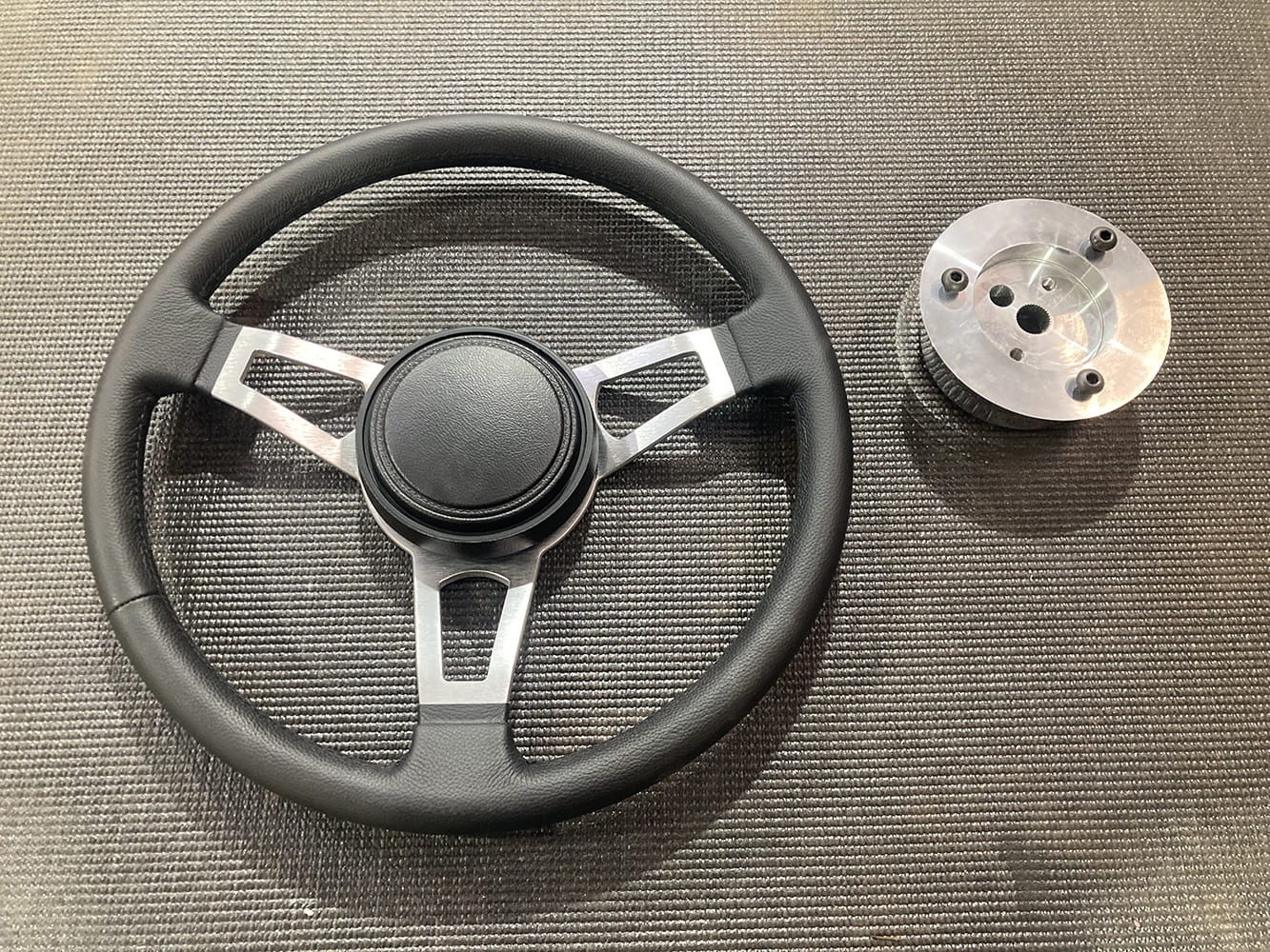 33 1964 Pontiac GTO new black leather 3 spoke steering wheel with billet adapter hub on bench