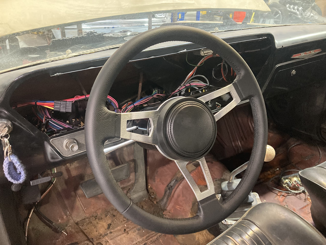 34 1964 Pontiac GTO new steering wheel installed on tilt column with visible wiring harness integration