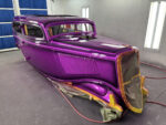 01 1930s classic car body with metallic purple flake paint in professional spray booth