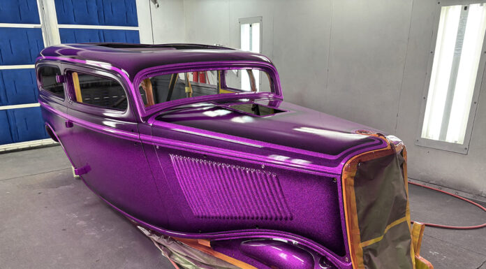 01 1930s classic car body with metallic purple flake paint in professional spray booth