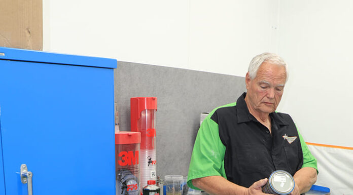 01 POR 15 top coat prep station with technician inspecting can before application