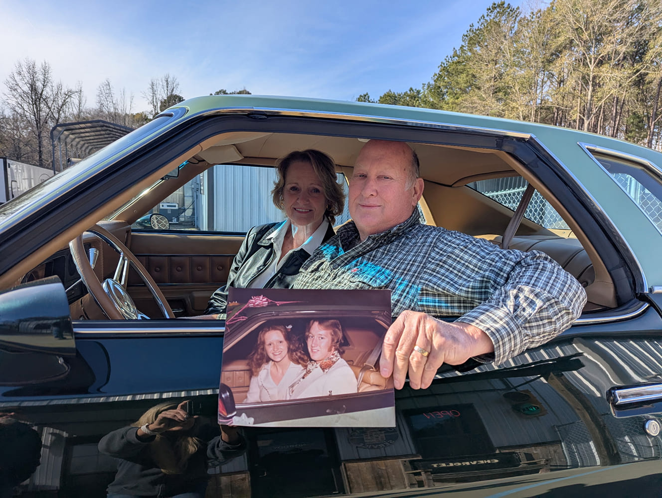 019 1977 Chevy Malibu couple with wedding photo inside restored car