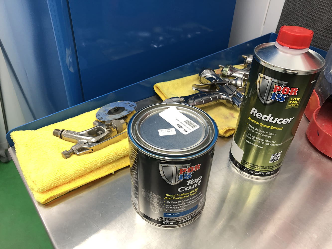 02 POR 15 top coat and reducer with spray gun on clean workstation