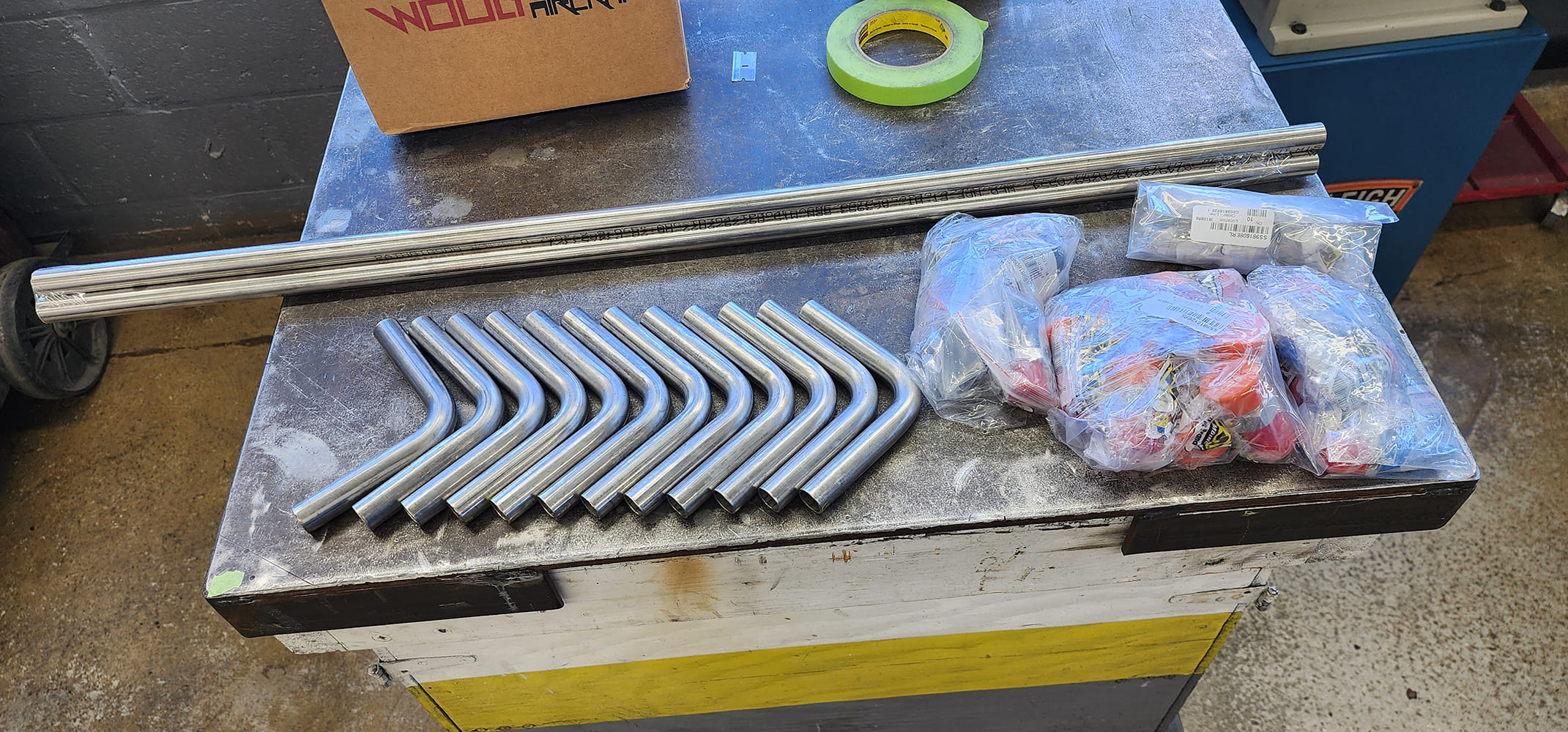 03 Workbench layout straight stainless pipes 90 degree bends fittings bags green tape