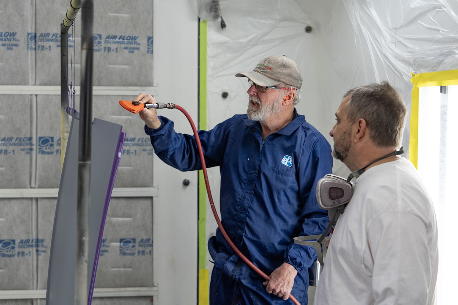 07 1930s Ford coupe body with fresh metallic purple paint drying in booth