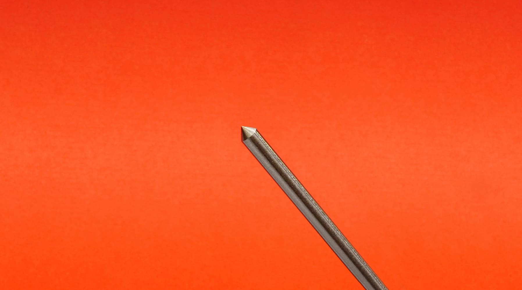 11 TIG tungsten electrode sharpened conical tip diagonal orientation orange background