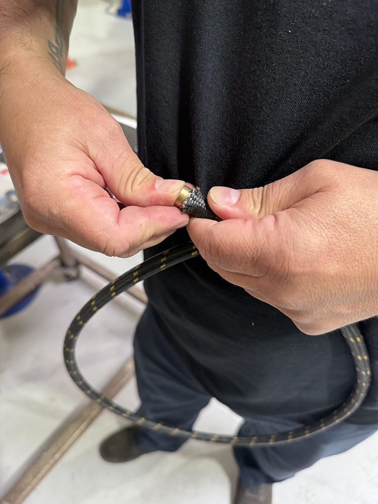 14 Inserting brass guide into braided hose core before AN fitting install