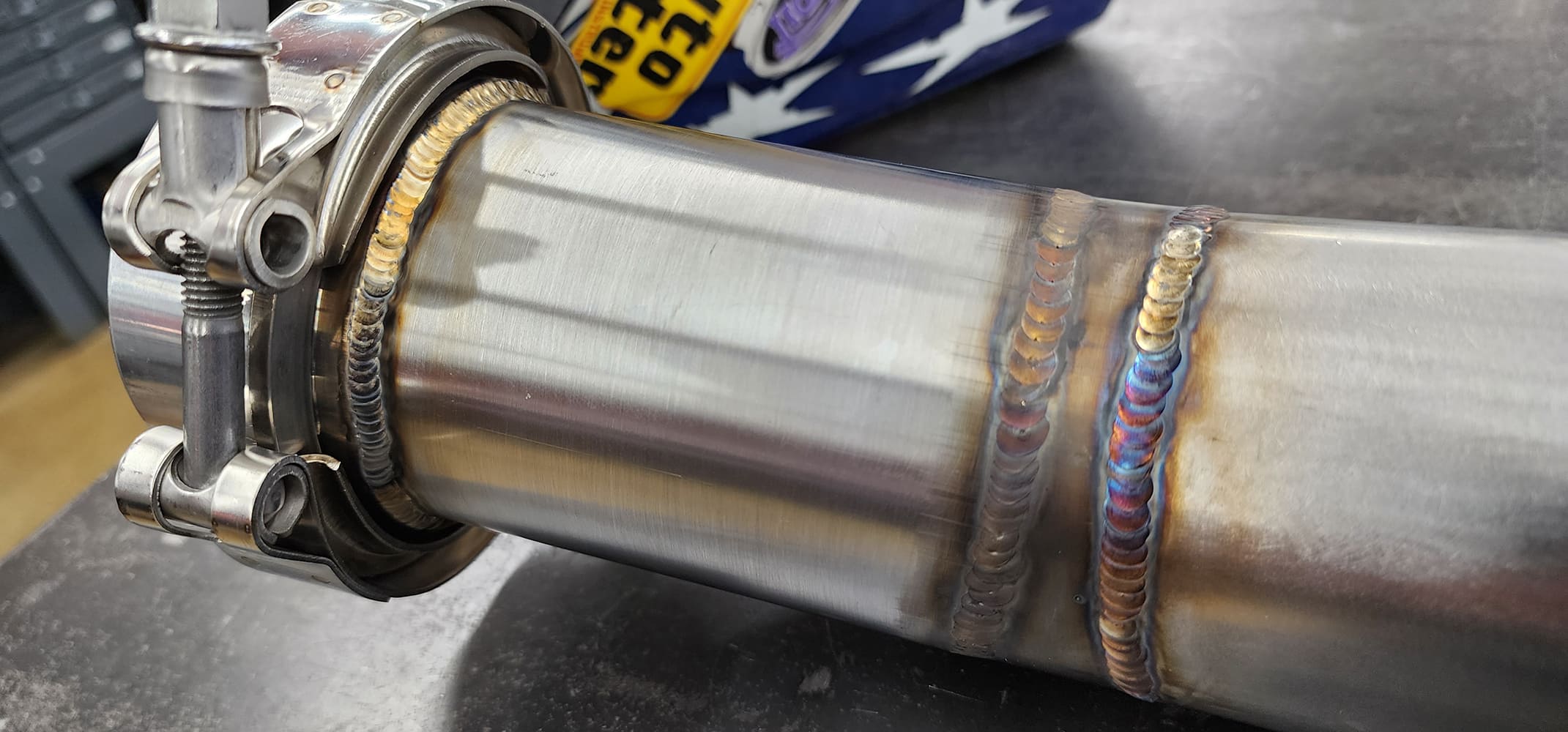 15 Close up exhaust welds V band clamp assembly heat discoloration Auto Body Specialists decal