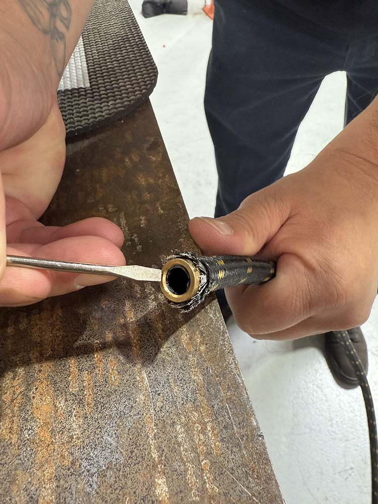 16 Spreading braided hose outer layer to verify alignment with brass insert