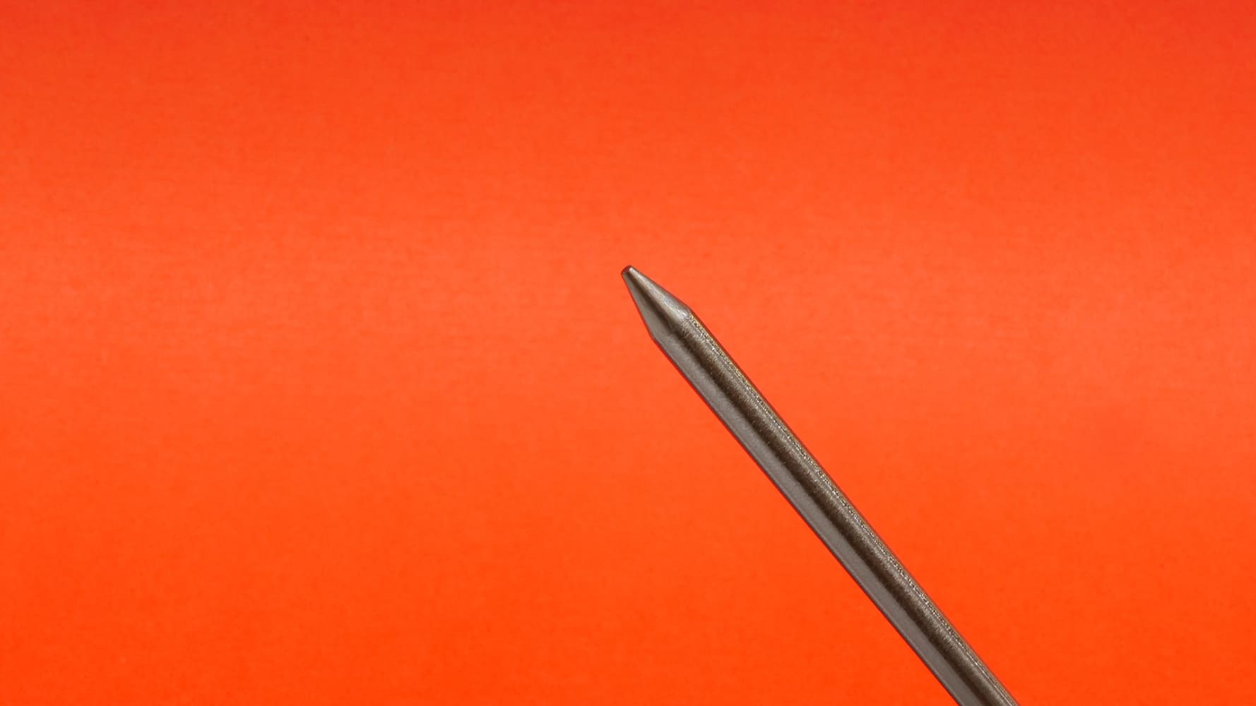 16 TIG torch with pink MILLER #5 cup tungsten protruding white collar visible orange background