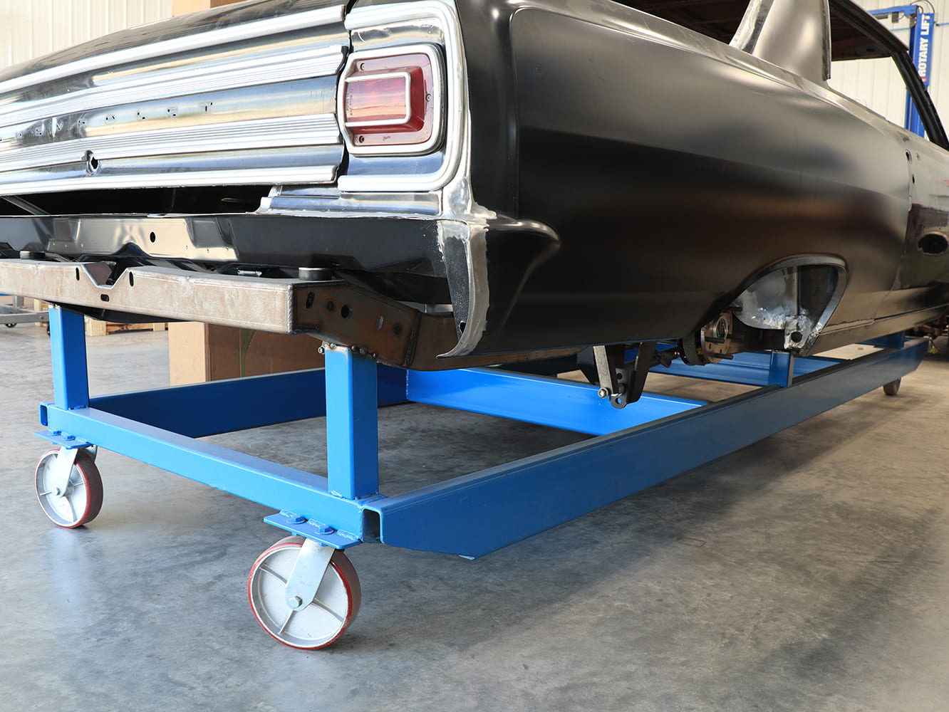 17 Black classic Mopar body mounted on blue dolly cart during restoration phase