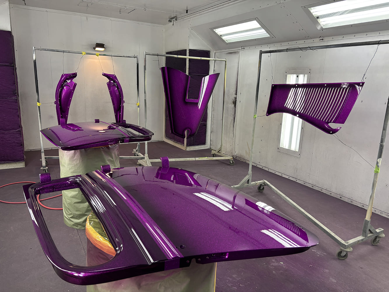 18 Classic Ford hot rod body panels drying after metallic purple flake paint application