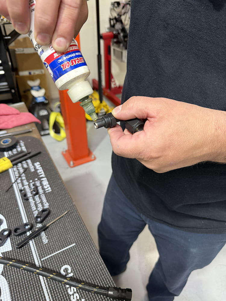 18 Lubricating AN fitting with Lucas Oil transmission fluid before insertion