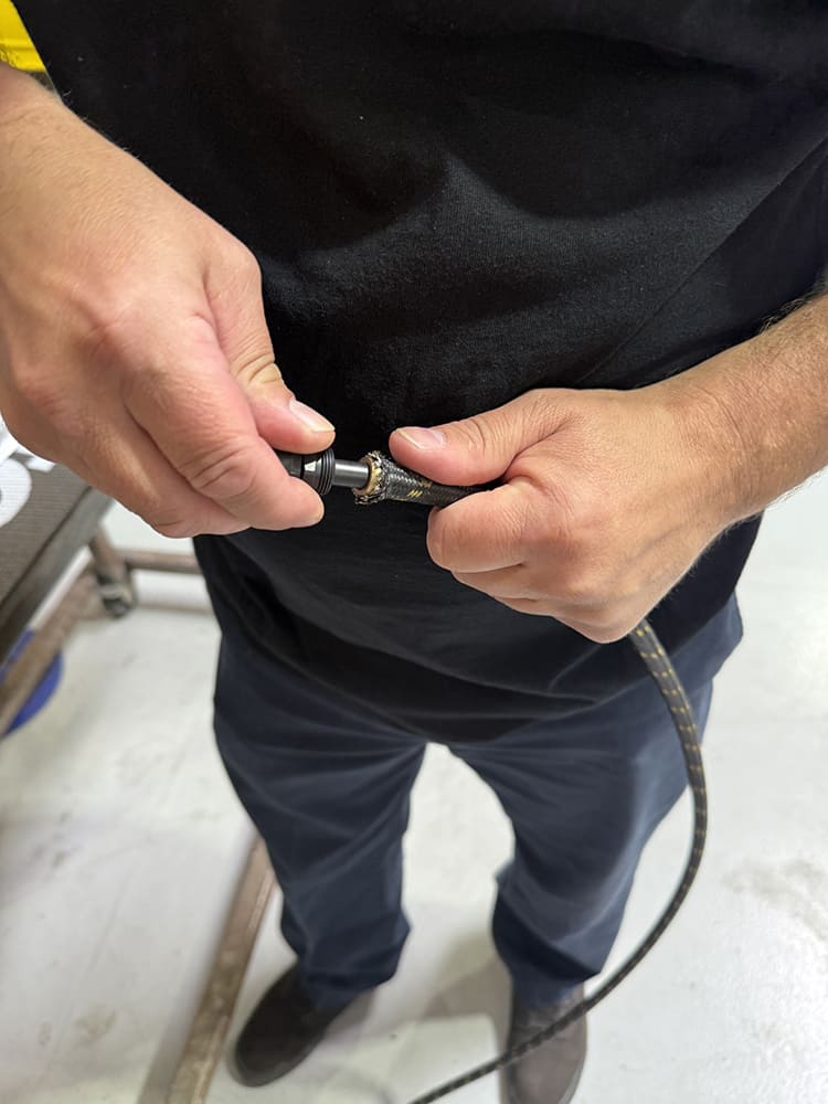 19 Installing AN fitting barb into prepared braided hose by hand twist