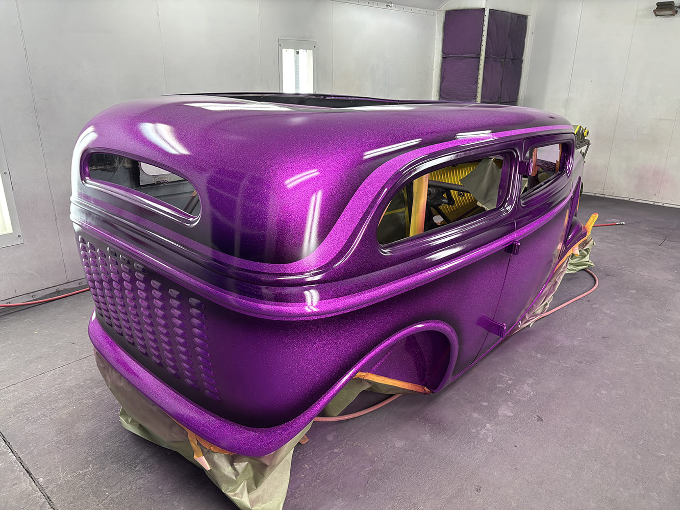 19 Rear view of 1934 Ford sedan hot rod with deep metallic purple flake paint