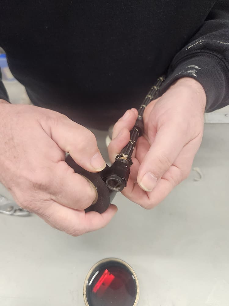 21 Starting angled AN fitting onto hose using soft jaw clamp for grip