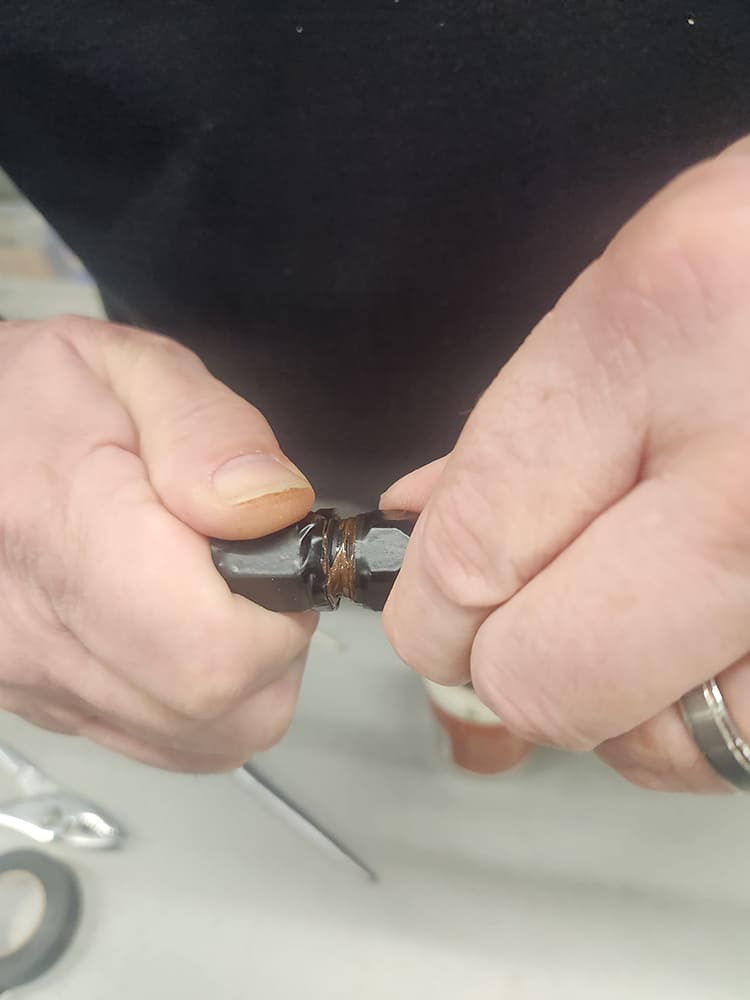 22 Tightening AN fitting collar showing thread sealant on braided line