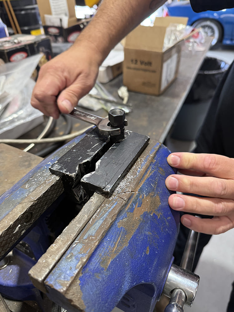 23 AN fitting final torque using vise jaws and wrench to complete assembly