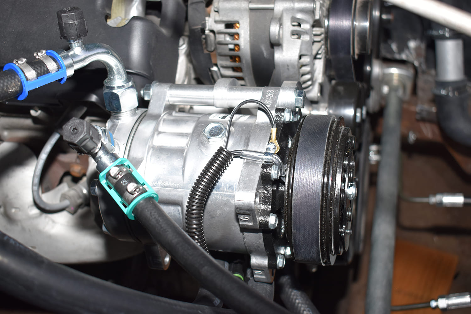 25 1951 Chevy AC compressor with blue and green spring lock clamps installed lines