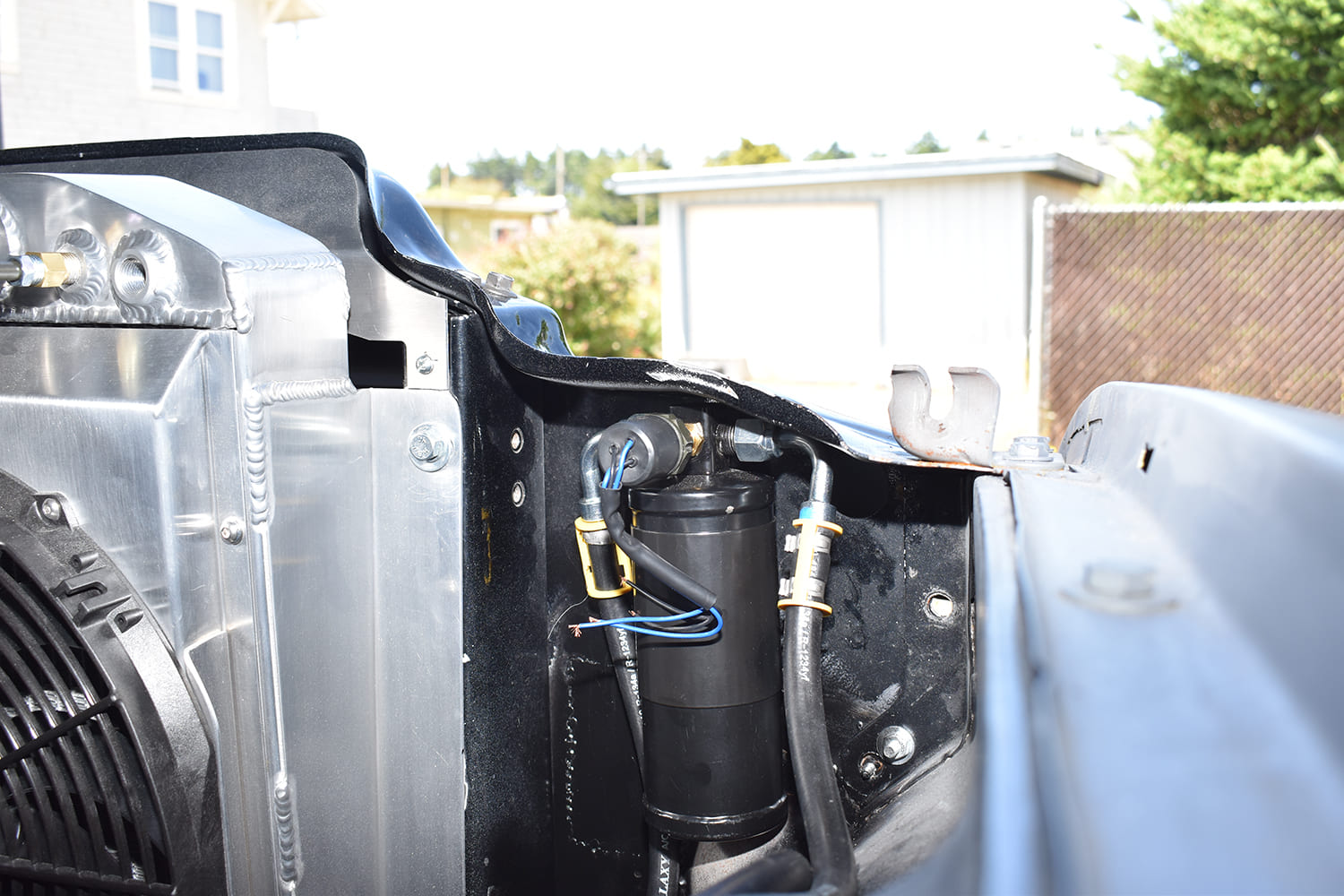 28 1951 Chevy AC system drier mounted behind grille support hard lines and wiring