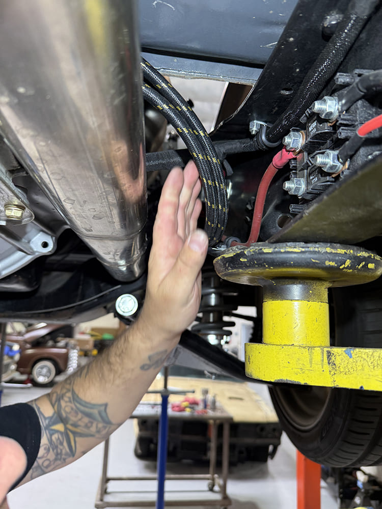 30 Routing braided hose under chassis near exhaust and suspension during fitment