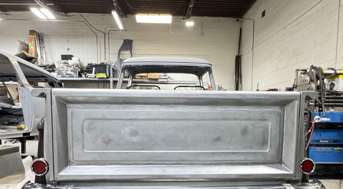 00 Chevy Task Force tailgate bare metal installed on truck chrome bumper taped red taillights shop with Miller Dynasty 350