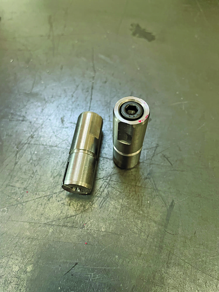 06 Two metallic bushings on workbench solid cylinder and sleeve bearing components