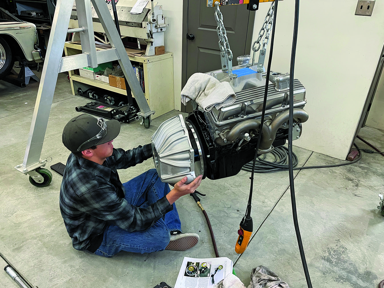 09 installing engine bellhousing assembly chain hoist positioning plaid shirt worker